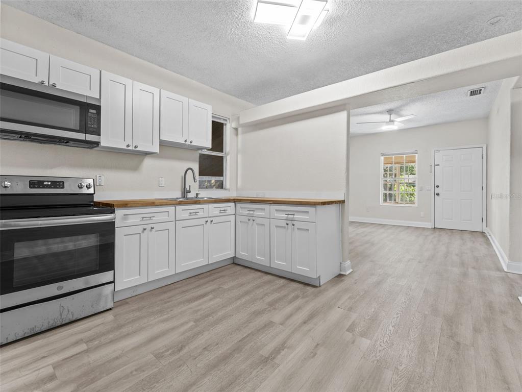 8210 North Klondyke Street, Unit 1 Tampa, FL 33604 - Photo 8 of 34 a kitchen with a cabinets and wooden floor