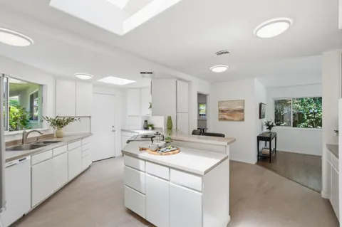 a kitchen with a sink stove and cabinets