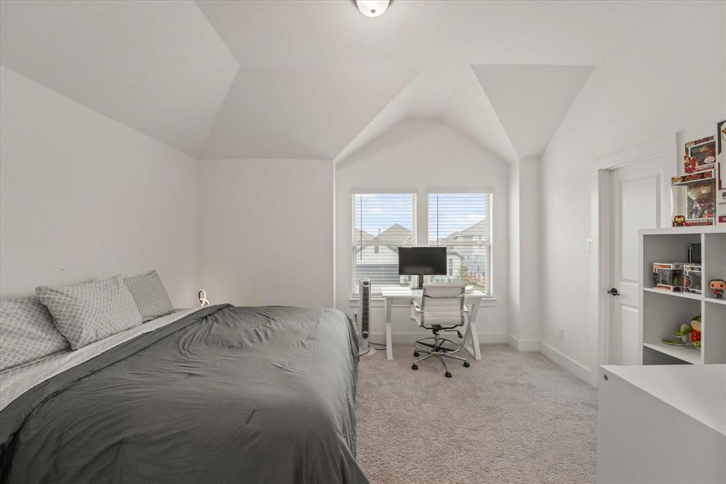 1714 Highwood Road Forney, TX 75126 - Photo 16 of 28 Bedroom with light carpet, vaulted ceiling, and an office area