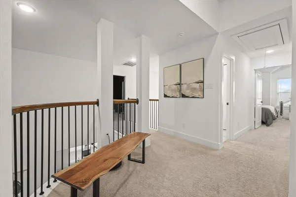 a view of a hallway with paintings on the wall