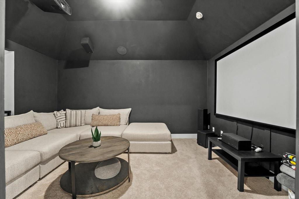 1714 Highwood Road Forney, TX 75126 - Photo 21 of 28 Cinema room featuring light colored carpet and lofted ceiling