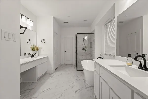 a spacious bathroom with a double vanity sink mirror double vanity and shower