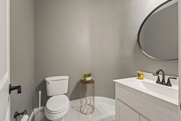 a white toilet sitting next to a bathroom sink
