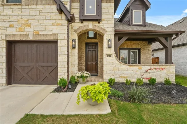 a front view of a house with garden