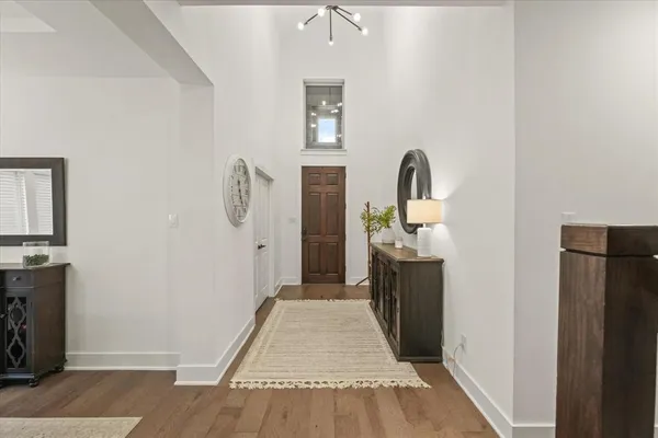 a view of a hallway with wooden floor and staircase