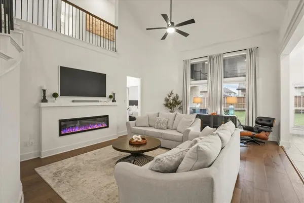 a living room with furniture flat screen tv and a fireplace