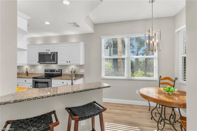 a kitchen with granite countertop lots of counter top space and dining table