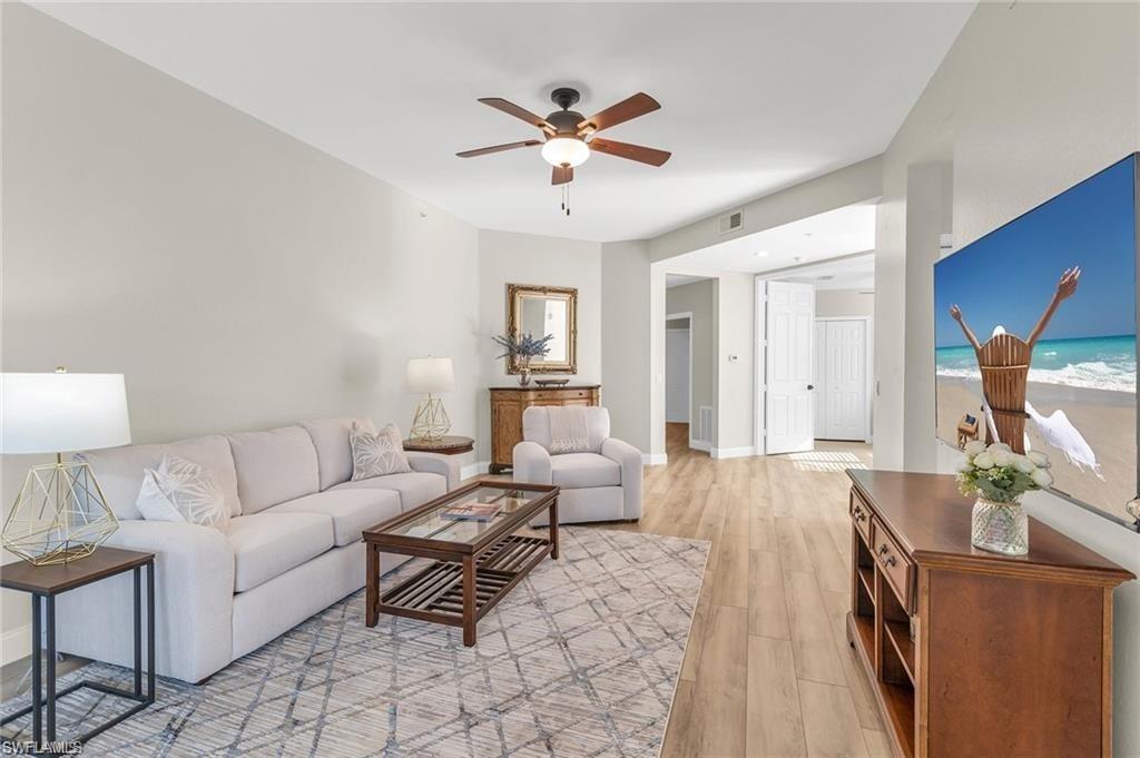 4705 Hawks Nest Way, Unit F101 Naples, FL 34114 - Photo 13 of 41 a living room with furniture and a chandelier