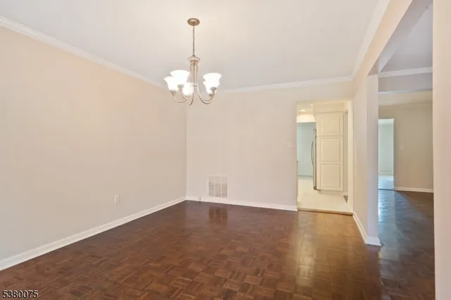 a view of livingroom with hallway and wooden floor