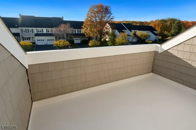 a view of a chair and table in the back yard of the house