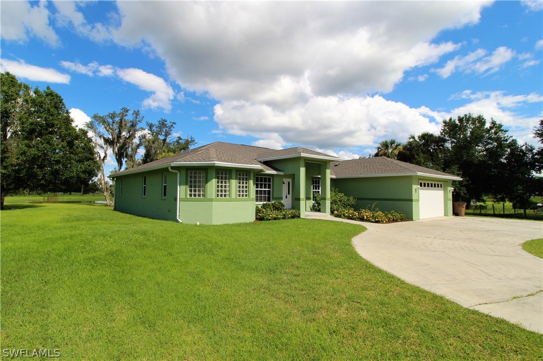 2771 Packinghouse Road Alva, FL 33920 - Photo 8 of 35 a view of a house with a yard