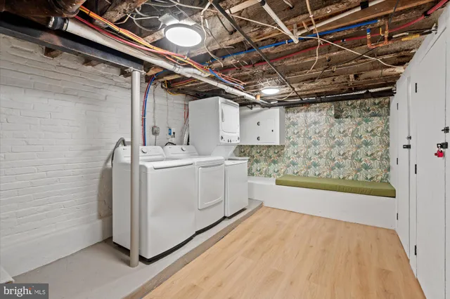 a kitchen with stainless steel appliances a dining table chairs refrigerator and microwave