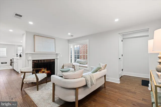 a living room with furniture and a view of kitchen
