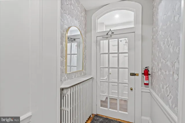 a view of a livingroom with wooden floor and windows