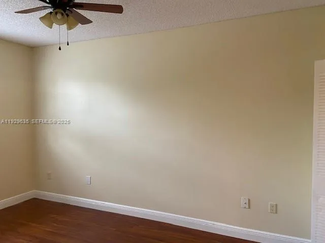 an empty room with a fan