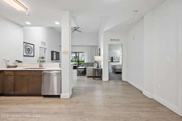 an empty room with wooden floor and a glass door