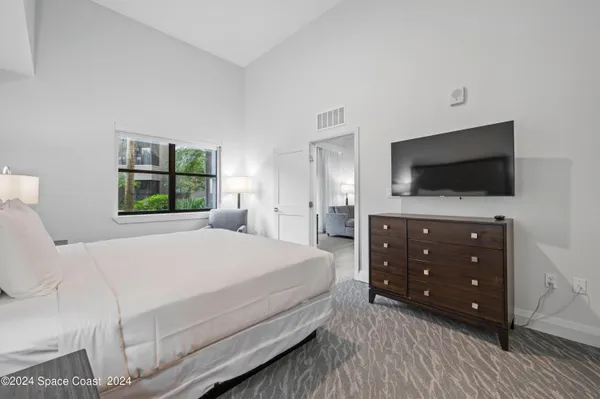 a bedroom with a bed and a couch