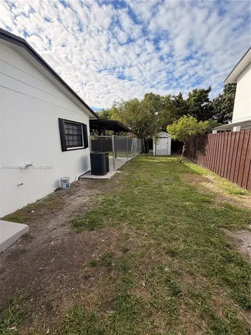 a view of a backyard of the house