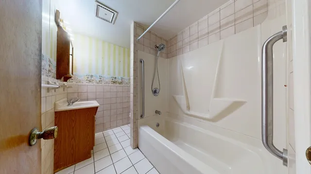 a bathroom with a bathtub a toilet and a shower