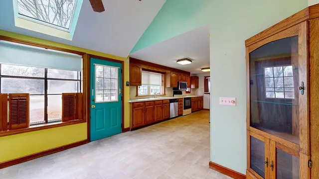 a view of a kitchen with kitchen island a sink a counter top space and stainless steel appliances