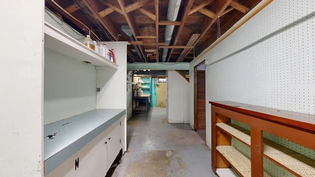 a view of an empty room with furniture and a window