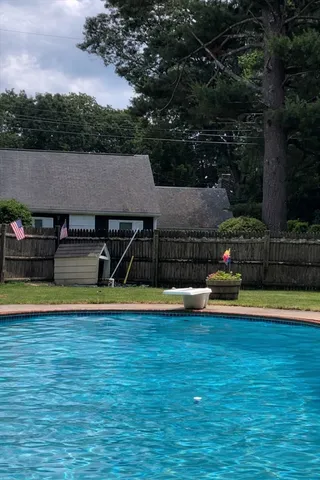 a view of a big yard with wooden fence
