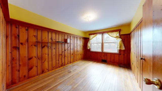 wooden floor in a room next to a window