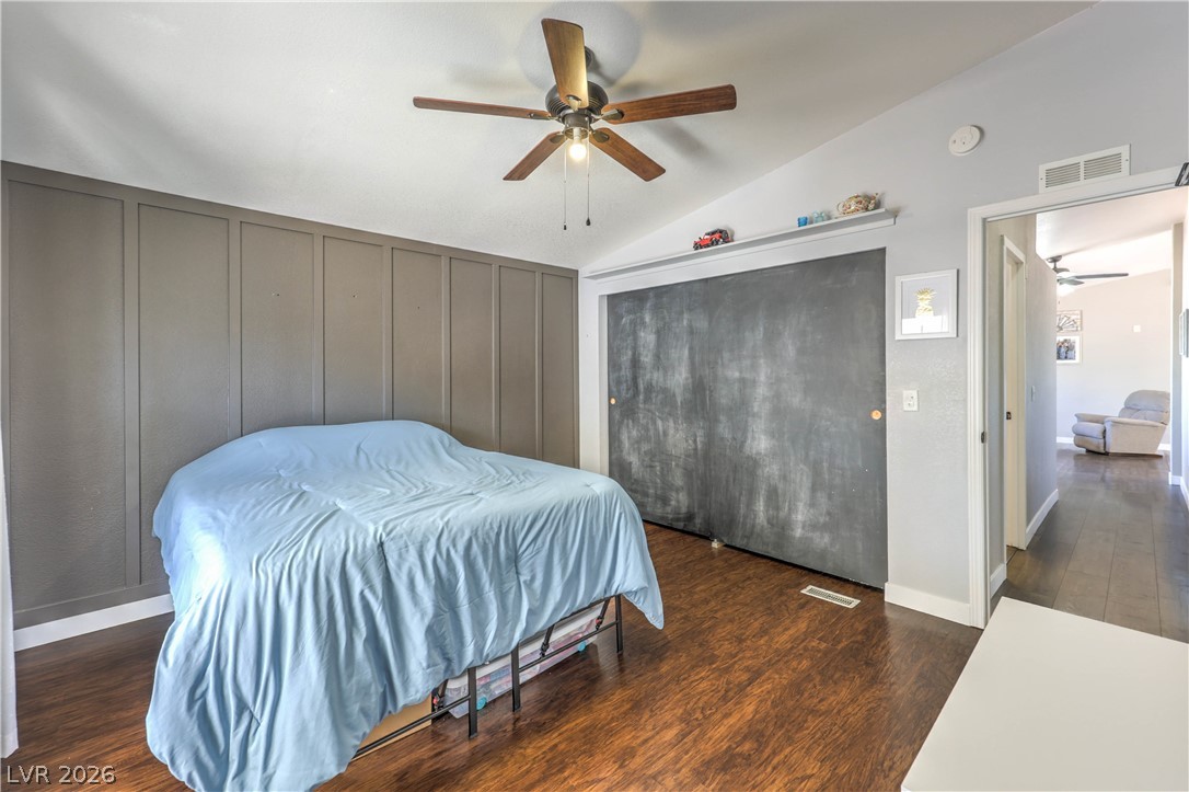 348 Tres Palomas Street Overton, NV 89040 - Photo 24 of 41 Rich wood flooring complements the textured wall in this comfortable bedroom.