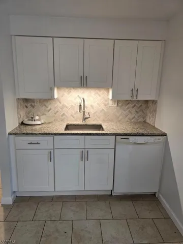 a kitchen with granite countertop cabinets and sink