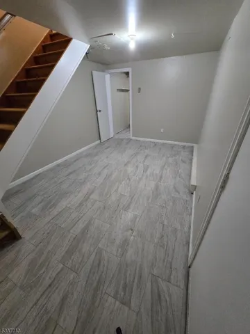 a view of hallway with wooden floor