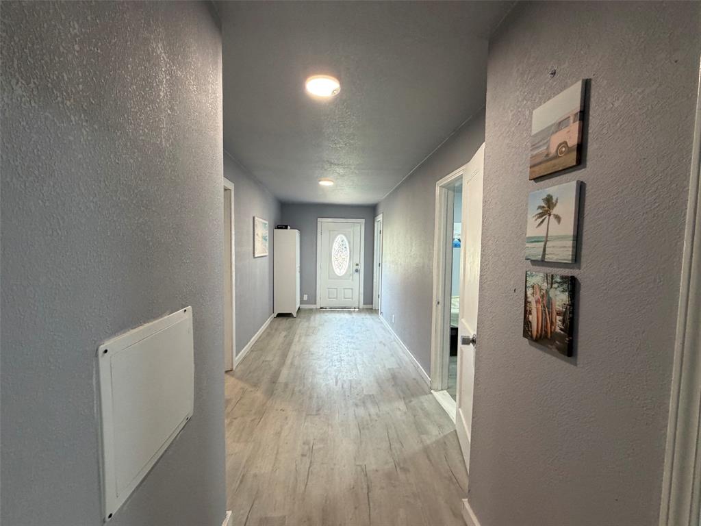 714 Southwest Dallas Street Grand Prairie, TX 75051 - Photo 21 of 27 Long hallway featuring light wood-finish flooring and recessed ceiling lighting