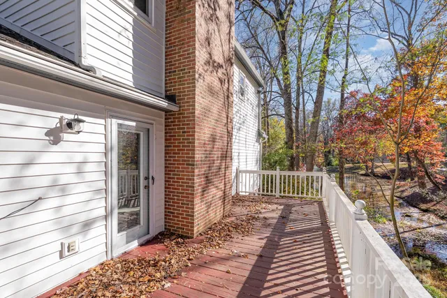 a porch with a bench next to a yard