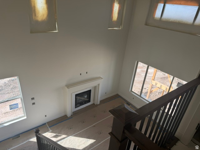 1931 South Fitzroy Road Ogden, UT 84401 - Photo 5 of 12 Built-in fireplace with a white mantel, dark wood newel posts, dark wood balusters, and transom windows