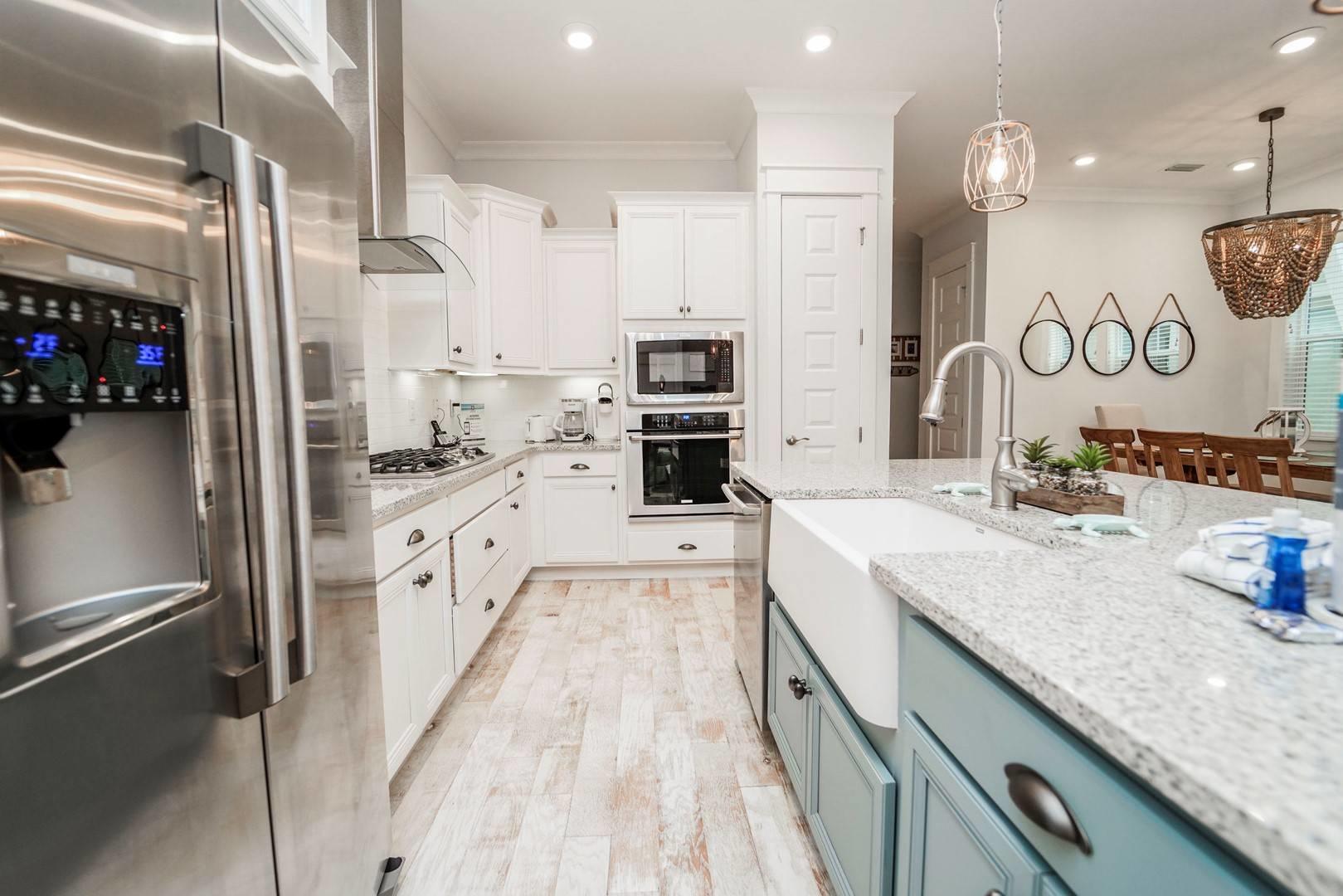 88 West W Pine, Unit A Inlet Beach, FL 32461 - Photo 3 of 19 a large kitchen with stainless steel appliances kitchen island a large counter top a stove a sink and a refrigerator