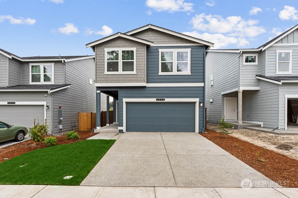 4229 Pronghorn Place, Unit 20 Bremerton, WA 98310 - Photo 1 of 21 a front view of a house with a yard and garage