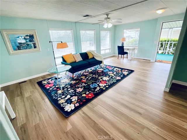 a living room with lots of furniture and a wooden floor