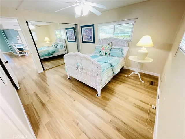 a bedroom with a bed mirror and a dresser