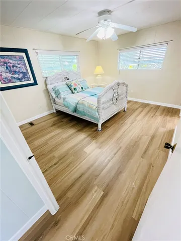 a bedroom with a bed and a painting on the wall