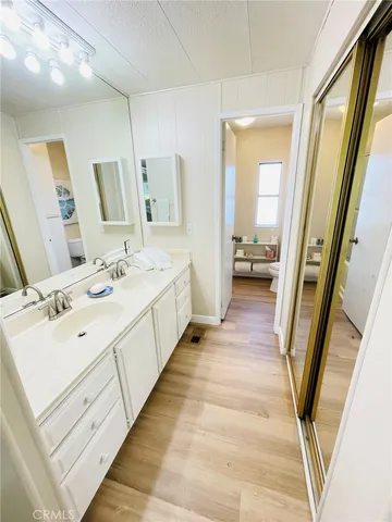 a spacious bathroom with a double vanity sink and a large mirror next to a window