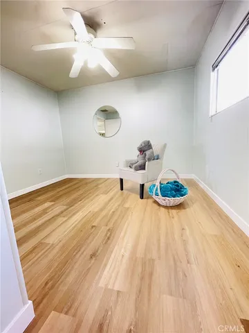 a bedroom with a bed and a chandelier fan