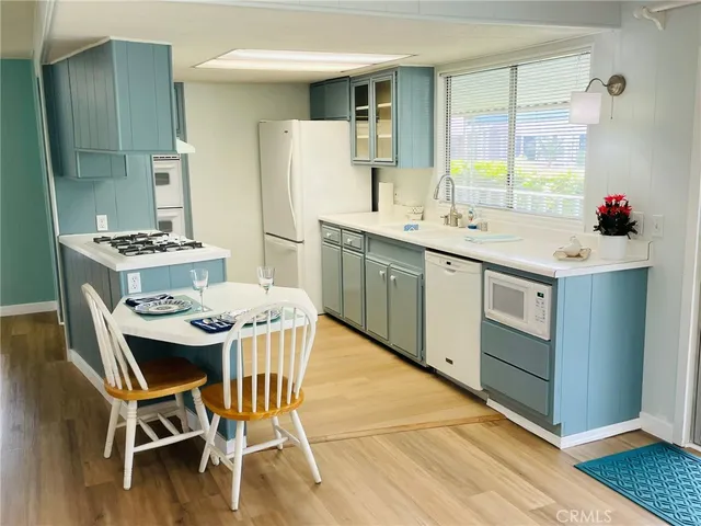 a kitchen that has a table and chairs in it