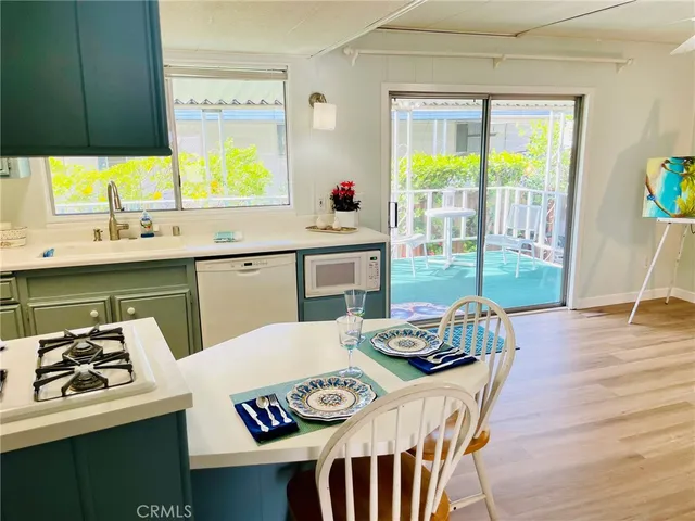 a kitchen with a table chairs and a window