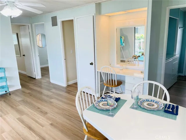 a view of a dining room with furniture a chandelier and wooden floor