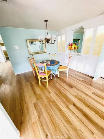 a view of a dining room with a table and chairs