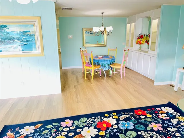 a view of a dining room with furniture and a chandelier