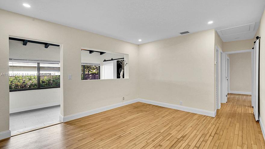 3764 Southwest 27th Lane, Unit 3762 Miami, FL 33134 - Photo 11 of 31 a view of empty room with wooden floor and fan