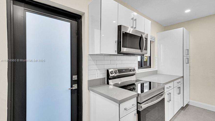 3764 Southwest 27th Lane, Unit 3762 Miami, FL 33134 - Photo 14 of 31 a kitchen with a stove and a microwave