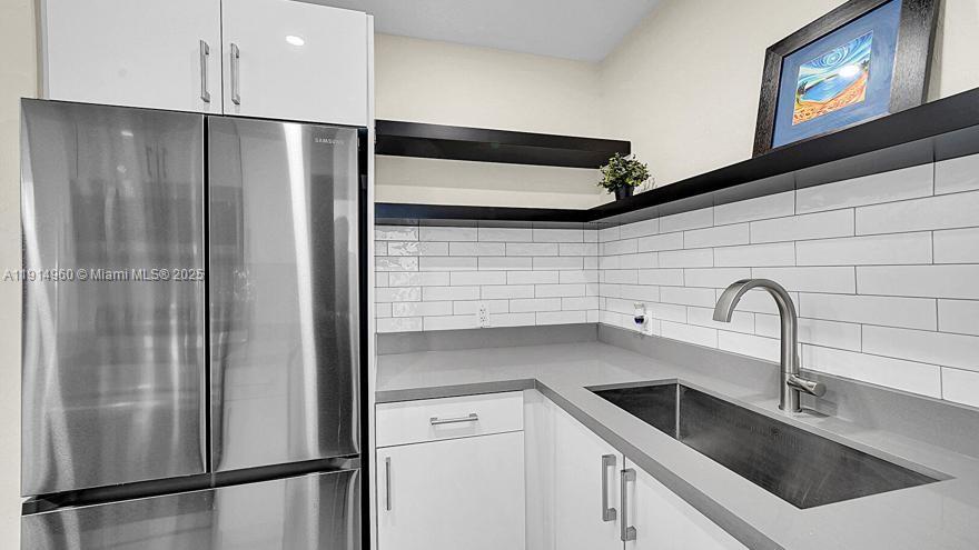 3764 Southwest 27th Lane, Unit 3762 Miami, FL 33134 - Photo 15 of 31 a kitchen with a refrigerator and a sink