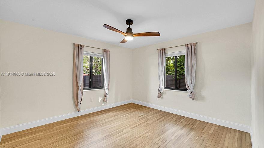 3764 Southwest 27th Lane, Unit 3762 Miami, FL 33134 - Photo 17 of 31 a view of an empty room with wooden floor and a window