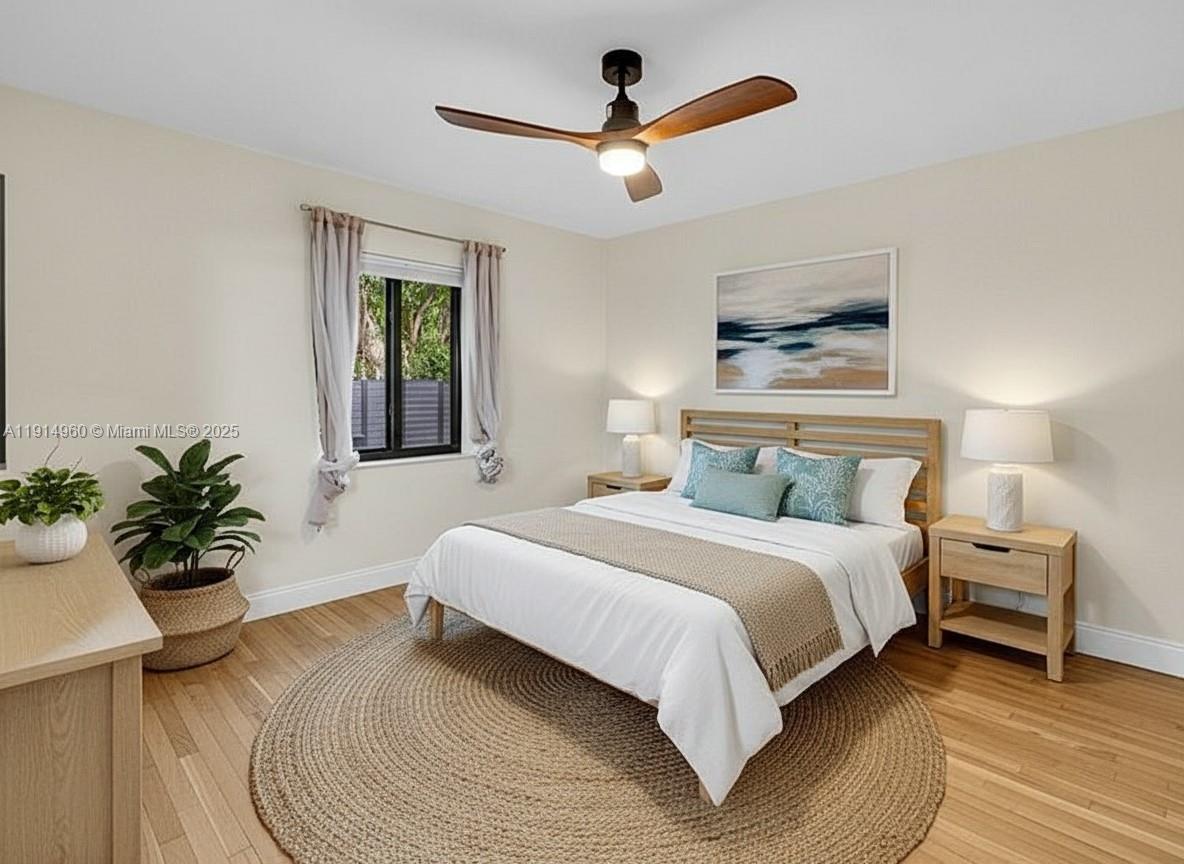 3764 Southwest 27th Lane, Unit 3762 Miami, FL 33134 - Photo 23 of 31 a bedroom with a large bed and a chandelier